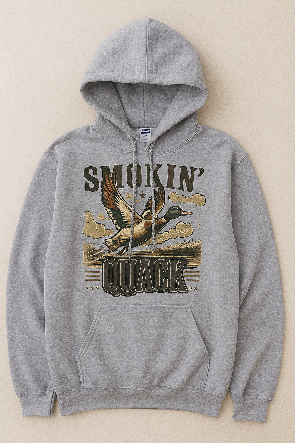 Heather gray Jerzees hoodie featuring the “Smokin’ Quack” flying duck graphic with vintage distressed lettering.